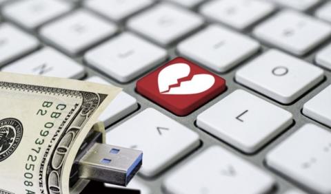 key board button with a broken heart and money around a USB drive